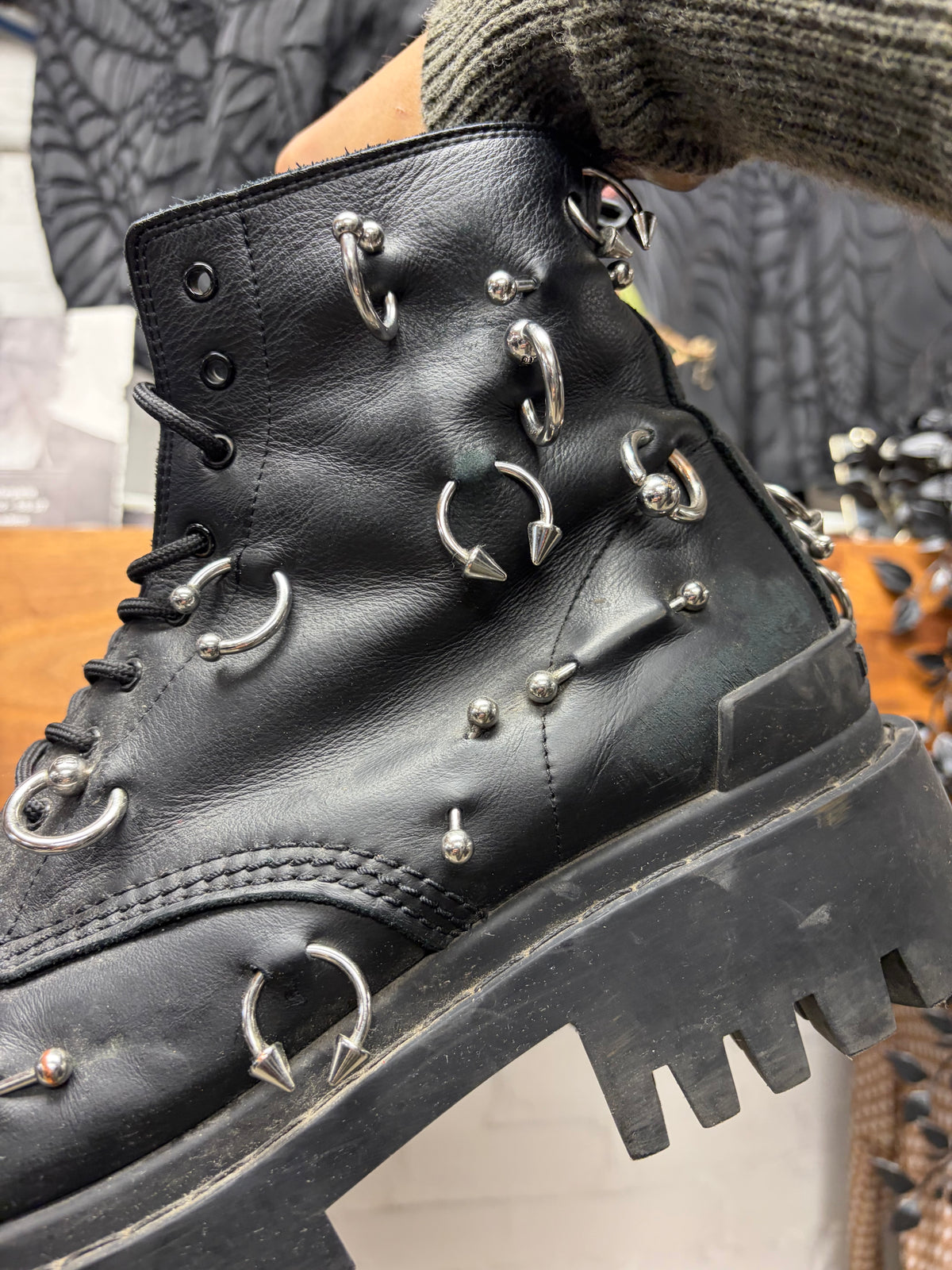 Balenciaga ‘Strike’ Piercing Distressed Black Leather Combat Boots
